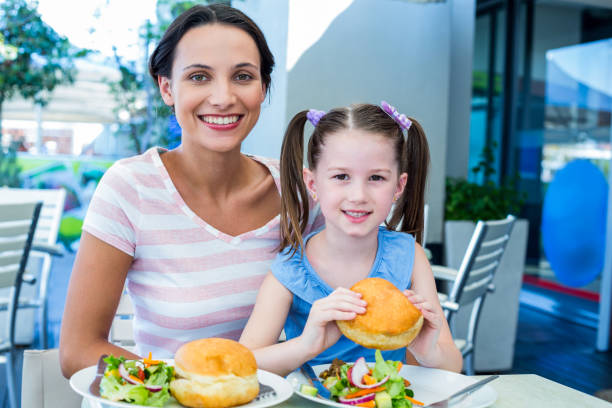 istock Daughter and mother eating at the restaurant 802845958