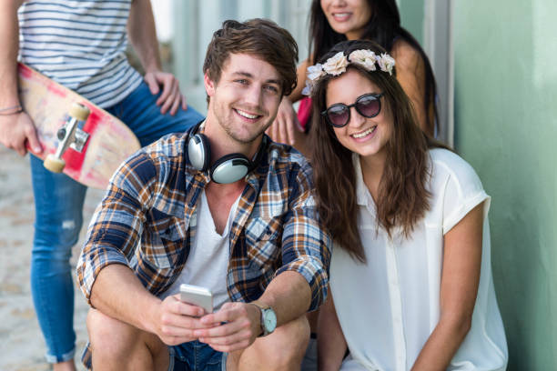 istock Hip friends sitting on steps looking at the camera 802846140