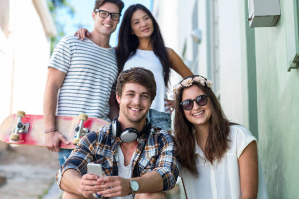 istock Hip friends looking at the camera and sitting on steps 802846154
