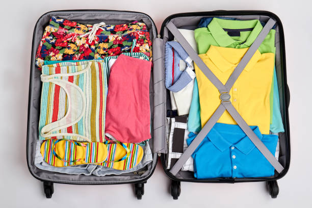 istock Colorful clothes in opened suitcases. 802846556