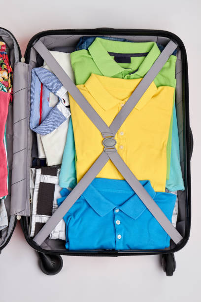 istock Suitcase full of man clothing. 802848826