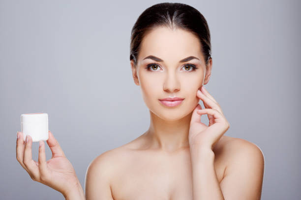 istock Beautiful girl holding cream 802852272