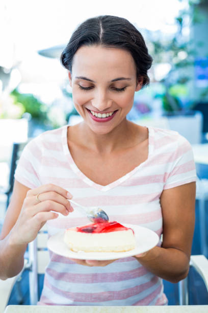 istock Smiling brunette taking a piece of chocolate cake 802856902