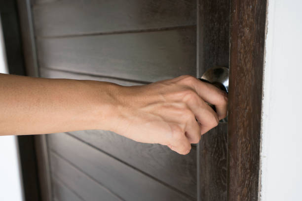 istock hand hold handle of door, close up 802857242