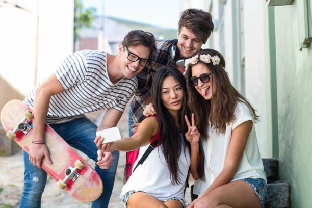 istock Hip friends taking selfie sitting on steps 802857262
