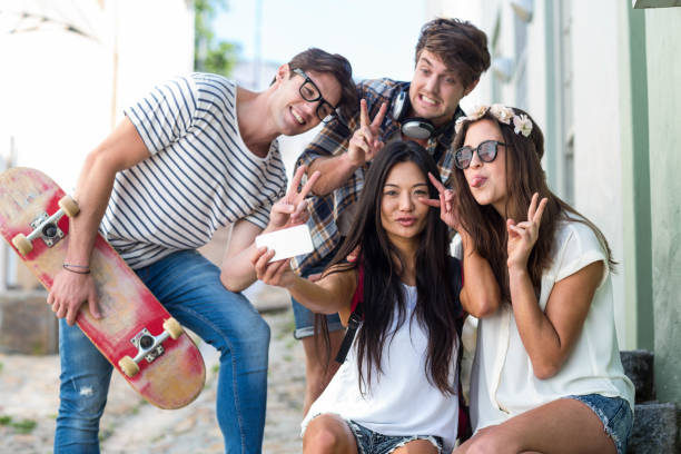 istock Hip friends taking selfie sitting on steps 802857284