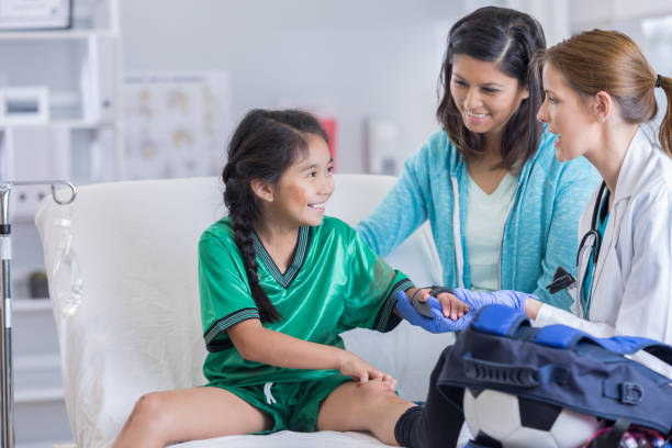 istock ER doctor talks with injured soccer player 802862832