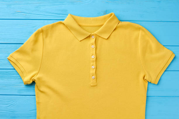 istock Yellow polo shirt, blue background. 802869716