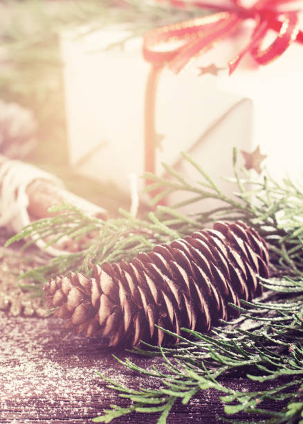Coniferous cone and gift box. Christmas decor in a vintage style. Selective focus