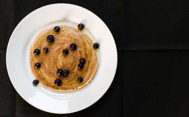 istock Tasty american pancake with blueberries and maple syrup. Selective focus. 802888770