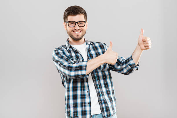 istock Young man showing thumbs-up aside 802907468