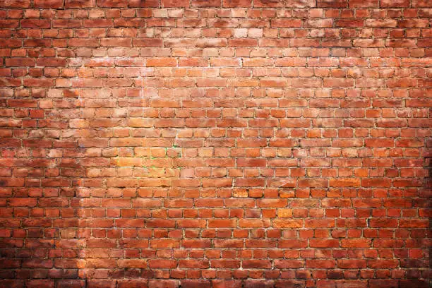 Photo of texture vintage brick wall, background red stone urban surface