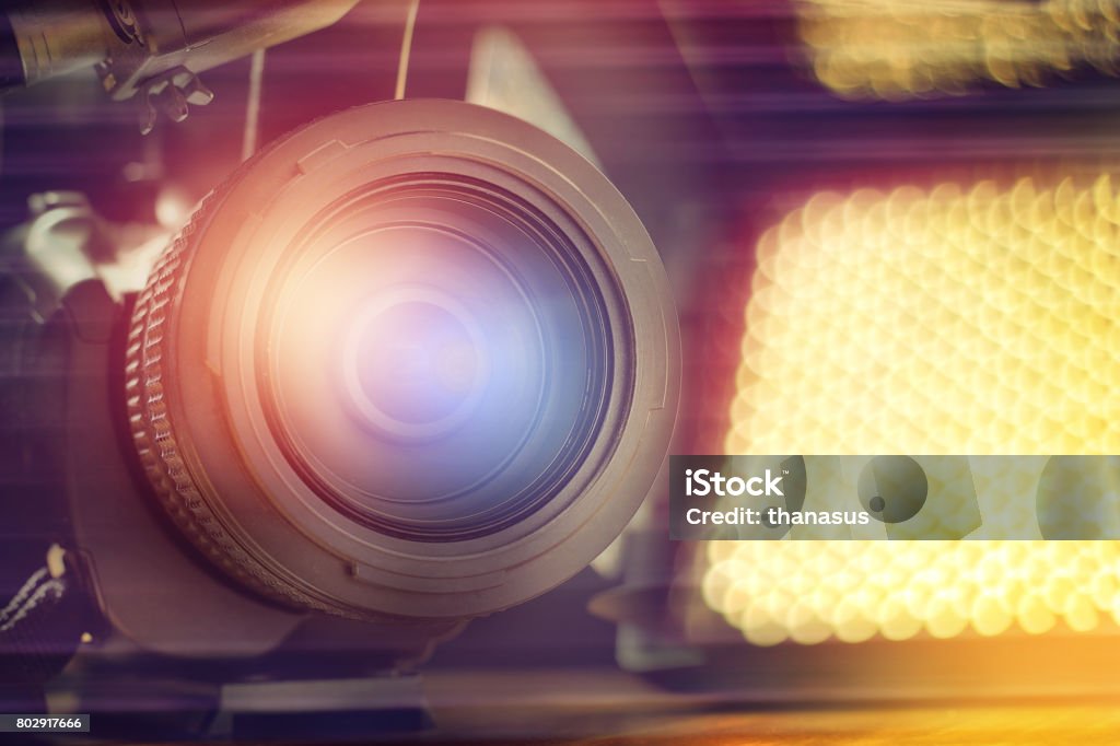 professional video camcorder in studio with blurred spot light background Interview - Event Stock Photo