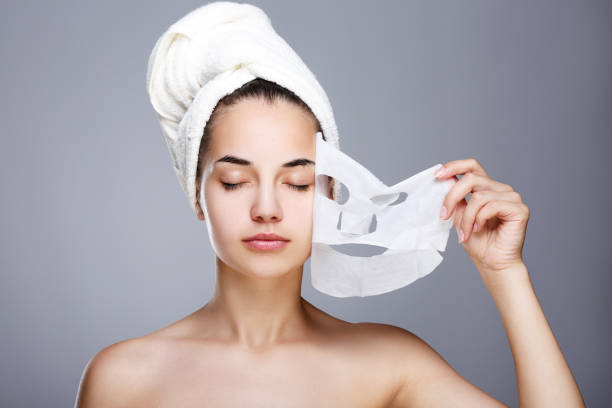 istock Girl with almost rended white mask 802918358