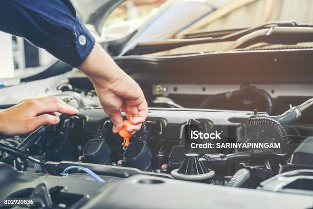 Car Mechanic Working In Auto Repair Service Stock Photo - Download Image Now - Engine, 30-39 Years, Adult