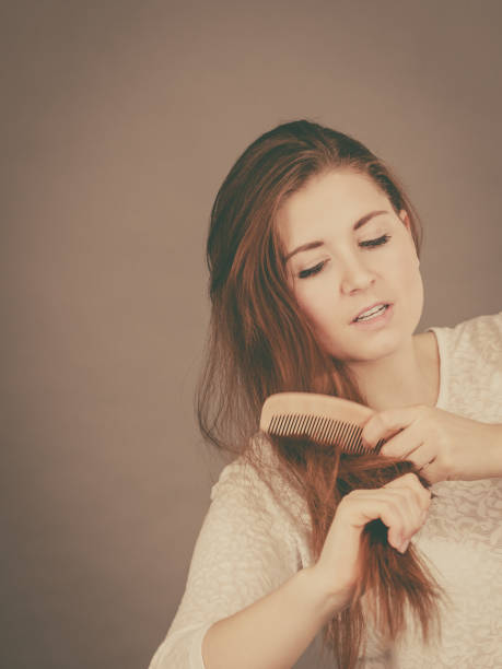 istock Happy woman brushing her hair 802921022