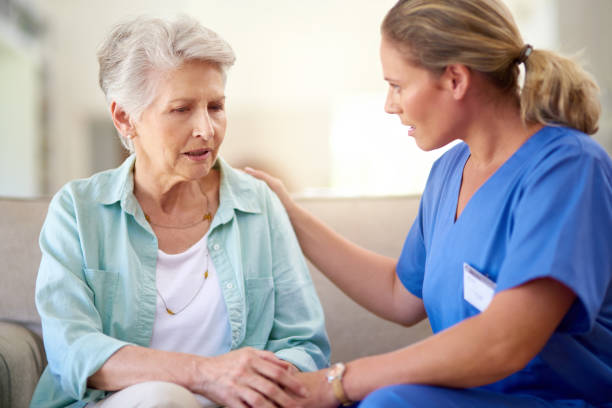 Sometimes my burdens and sorrows become too overwhelming to bear... Shot of a caregiver consoling a senior patient in a nursing home alzheimer patient stock pictures, royalty-free photos & images