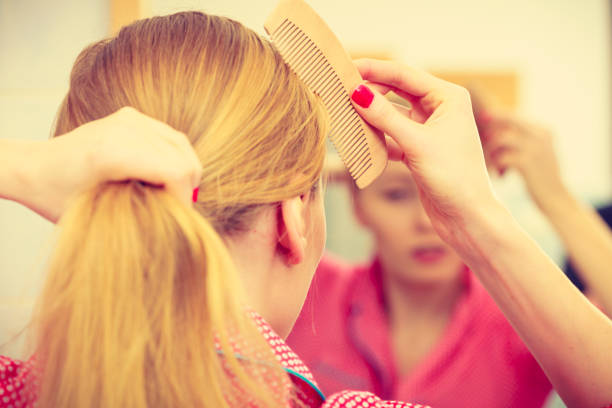 istock Woman combing her long hair in bathroom 802921102