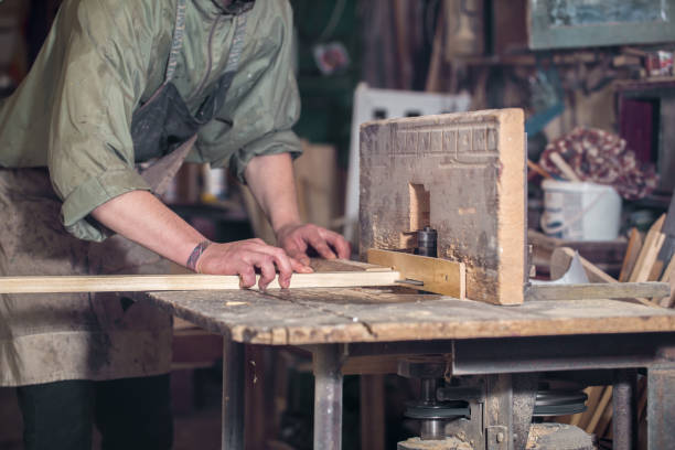 istock a man working with wood product on the machine 802928910