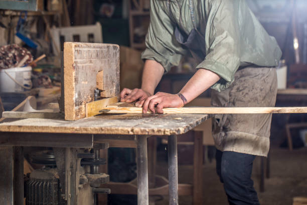 istock a man working with wood product on the machine 802928958