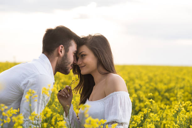istock Affectionate couple falling in love in a field of spring flowers. 802928968