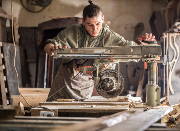 istock a man works on the machine with the wooden product 802929072