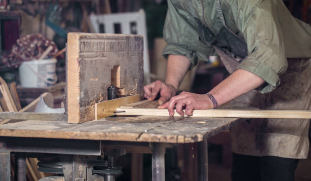 istock a man working with wood product on the machine 802929130