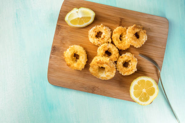 istock Calamari rings with lemon and copy space, overhead shot 802933810