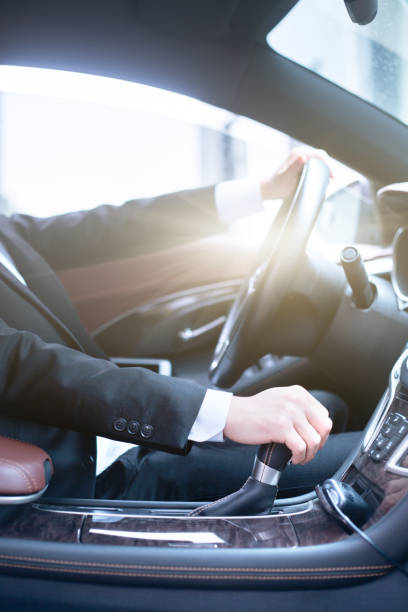istock young businessman driving his car 802938526