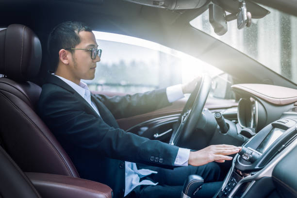 istock young businessman driving his car 802940610