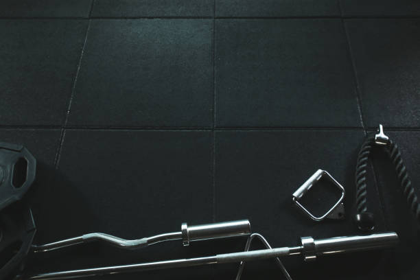istock Gym Equipment Background on the empty floor 802943004