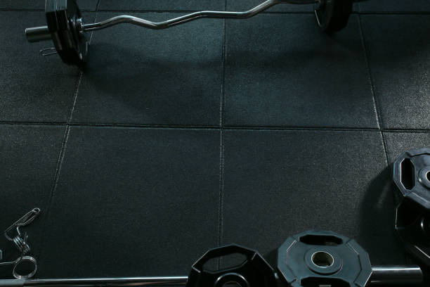 istock Barbell with weights plate on the floor gym 802943980