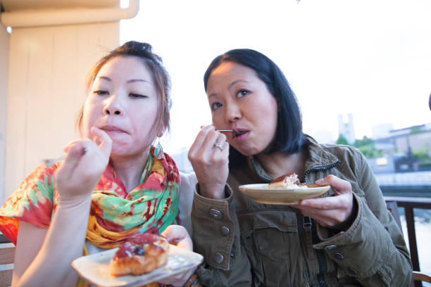 istock 2 Japanese women enjoying drink and cake 802947174