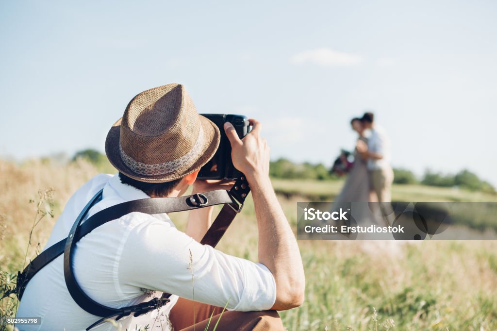 wedding photographer takes pictures of bride and groom in nature, fine art photo wedding photographer takes pictures of bride and groom in nature in summer, fine art photo Photographer Stock Photo