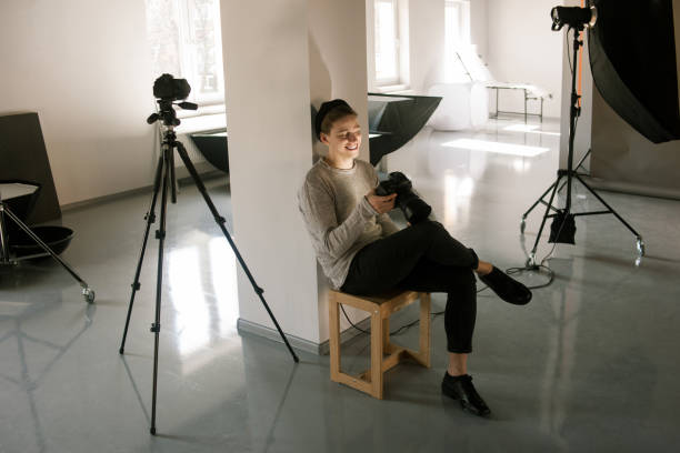 istock Photographer in studio enjoy pictures on camera 802977104