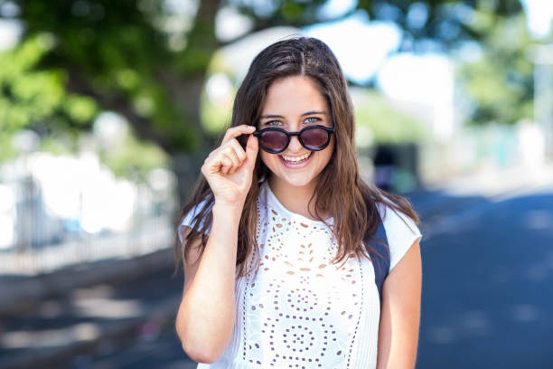 istock Hip girl holding her sunglasses 802977946