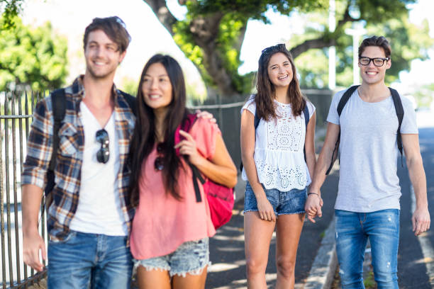 istock Hip couple with arms around posing for camera 802978028