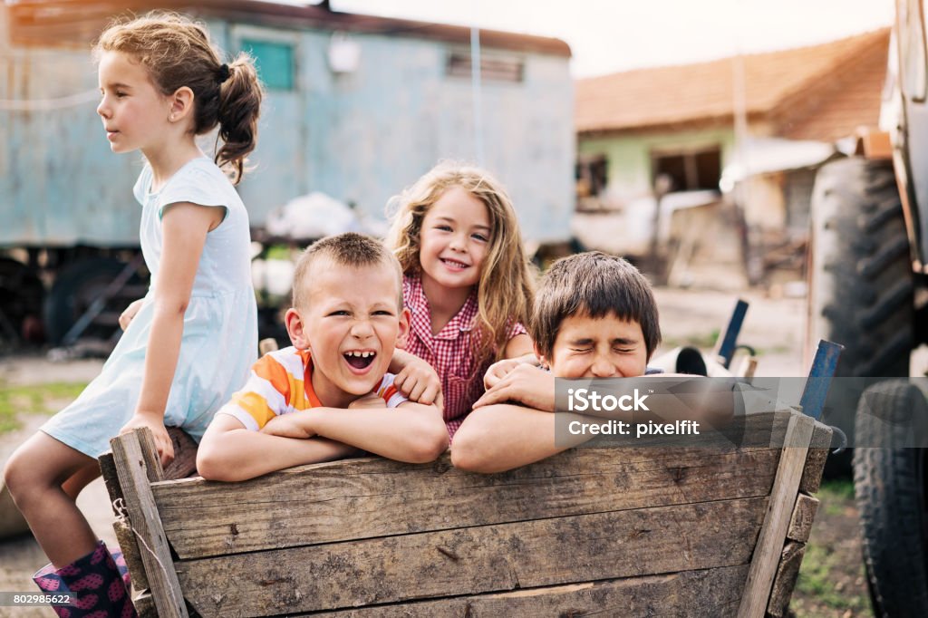 Kids playing in the ghetto Group of children playing outdoors in a poverty district Poverty Stock Photo