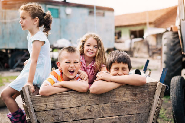 Kids playing in the ghetto Group of children playing outdoors in a poverty district poor village europe stock pictures, royalty-free photos & images