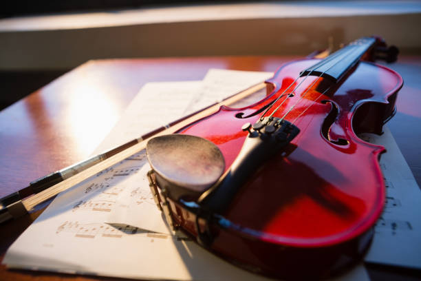 istock Close up of violin with sheet music on table 802986668