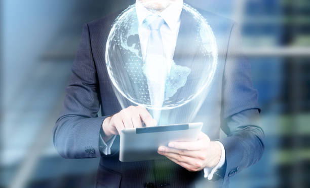 istock Man with tablet and Earth hologram 802990242