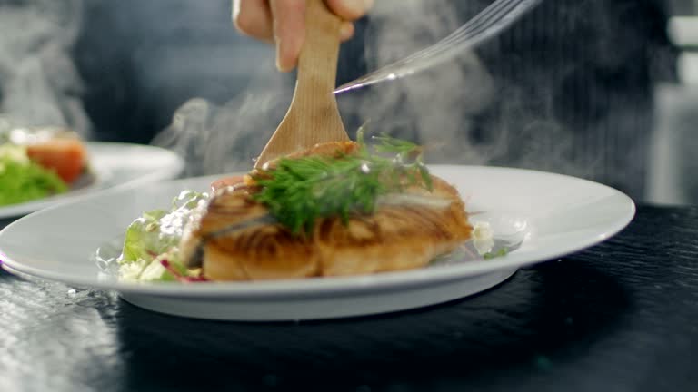 Portrait of a Young Woman Chef Smiling While Cooking in a Modern Kitchen.