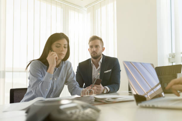 istock Businesswoman using mobile phone on a meeting 802991340
