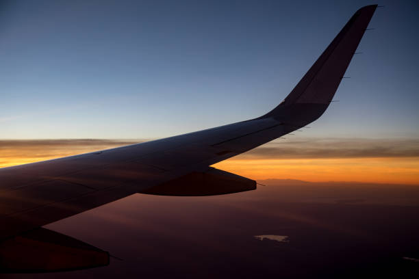 istock Airbus A320 wing flying at sunset 802998036