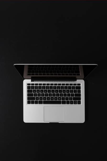 top view of modern laptop with copy space isolated on black top view of modern laptop with copy space isolated on black epithelium photos stock pictures, royalty-free photos & images