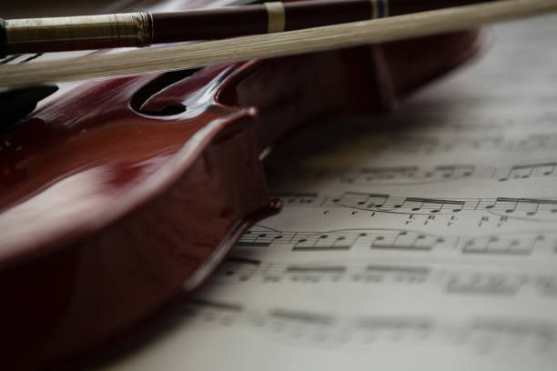 istock Close up of violin with sheet music on table 803040122