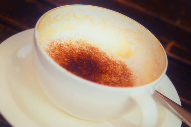 Cappuccino in a white cup on a white saucer. Still-life on a white background.
