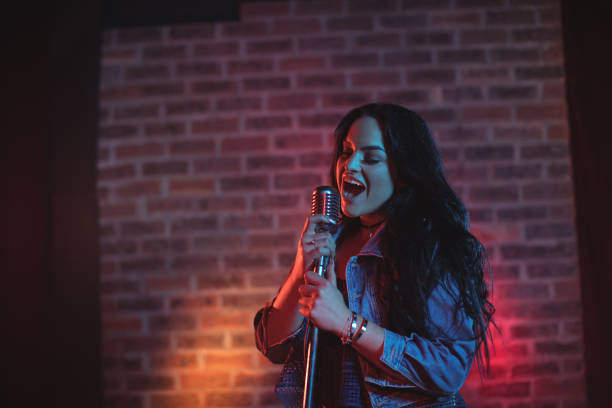 istock Cheerful singer singing illuminated nightclub 803050362