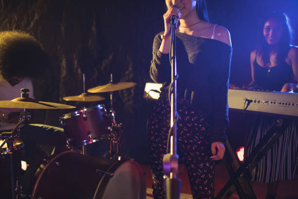 istock Ffemale singer performing with team in nightclub 803057022