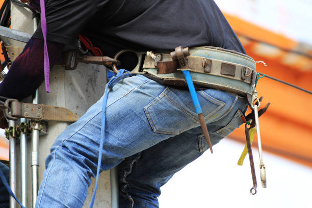 istock Tool Belt wearing by Electrician Climbing on Concrete Pole 803057210